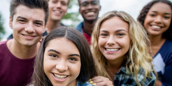 group of teens facing the viewer and smiling