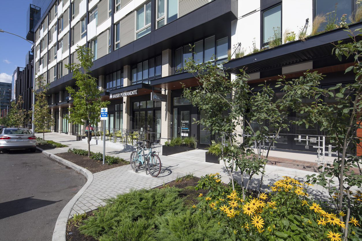 South Lake Union Kaiser facility with bike, trees, and flowers in front