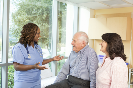 doctor speaking to patient and family